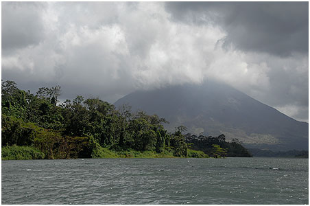 Volcano Arenal seen from the lake - unfortunately covered in the abundant clouds.
